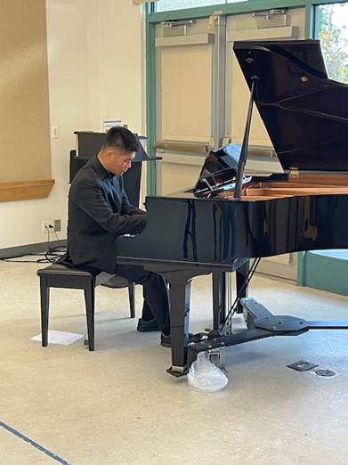 A person playing a piano

Description automatically generated